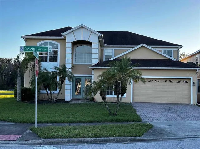 a front view of house with a garden