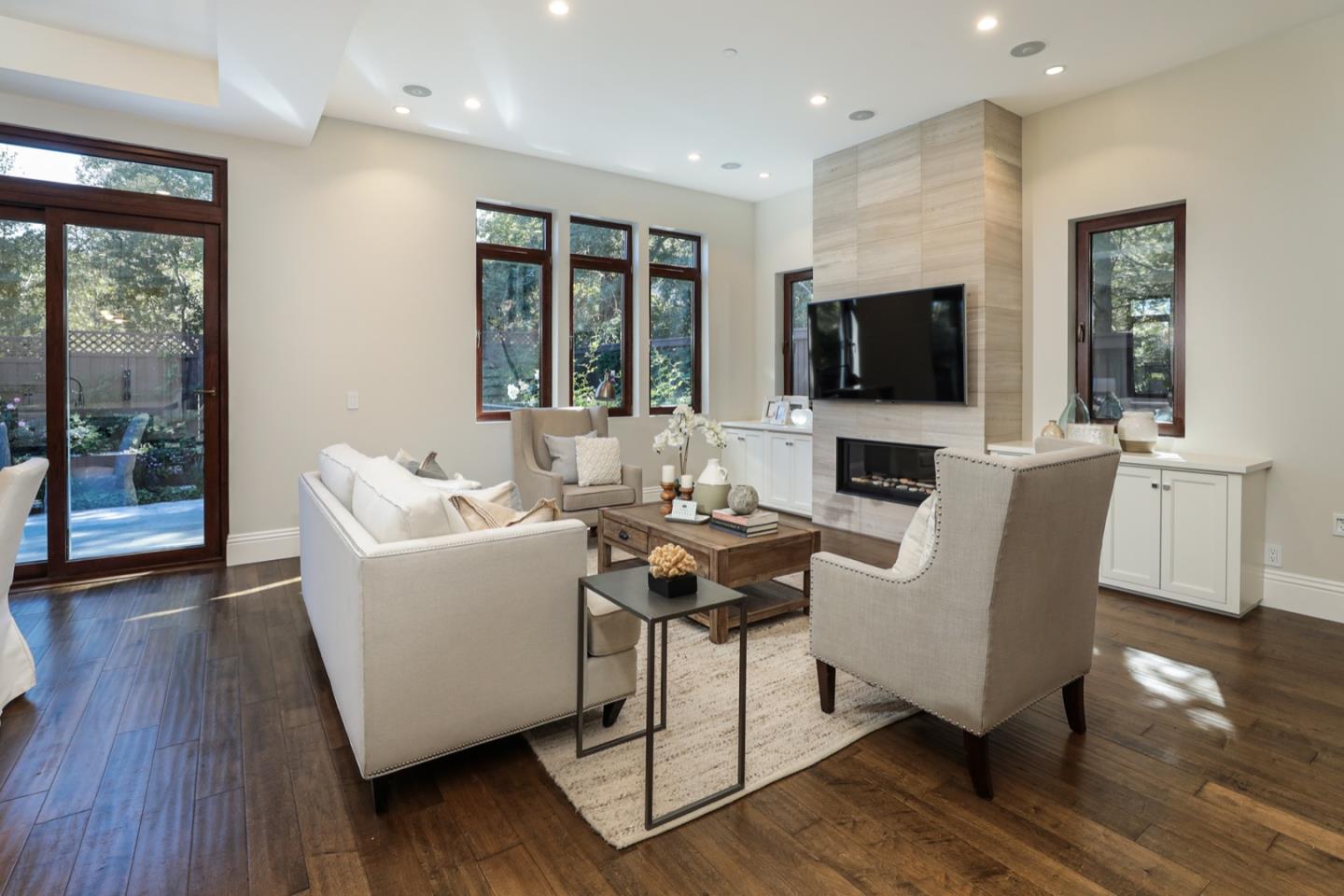 319 Walsh Road Atherton, CA 94027 - Photo 2 of 28 a living room with fireplace furniture and a flat screen tv