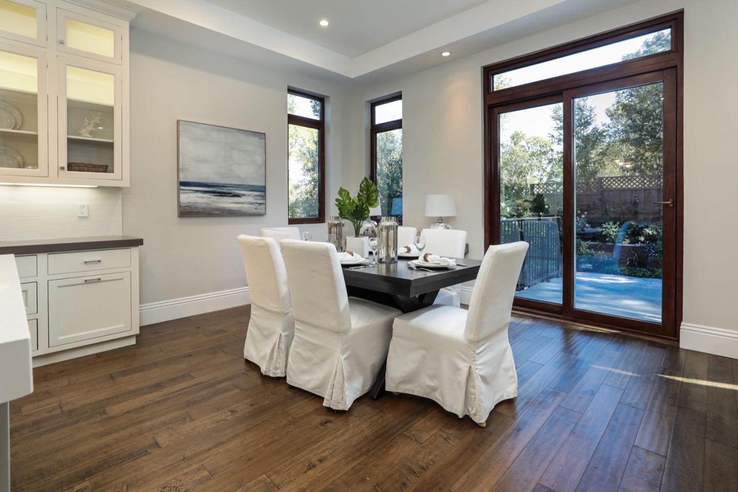 319 Walsh Road Atherton, CA 94027 - Photo 5 of 28 a dining room with wooden floor a glass table and chairs