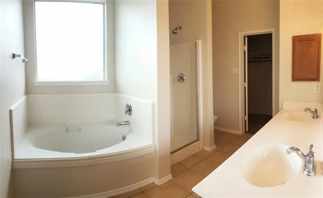 a bathroom with a tub and sink