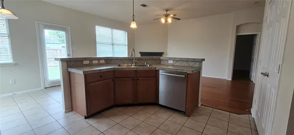a kitchen with stainless steel appliances granite countertop a sink and a stove