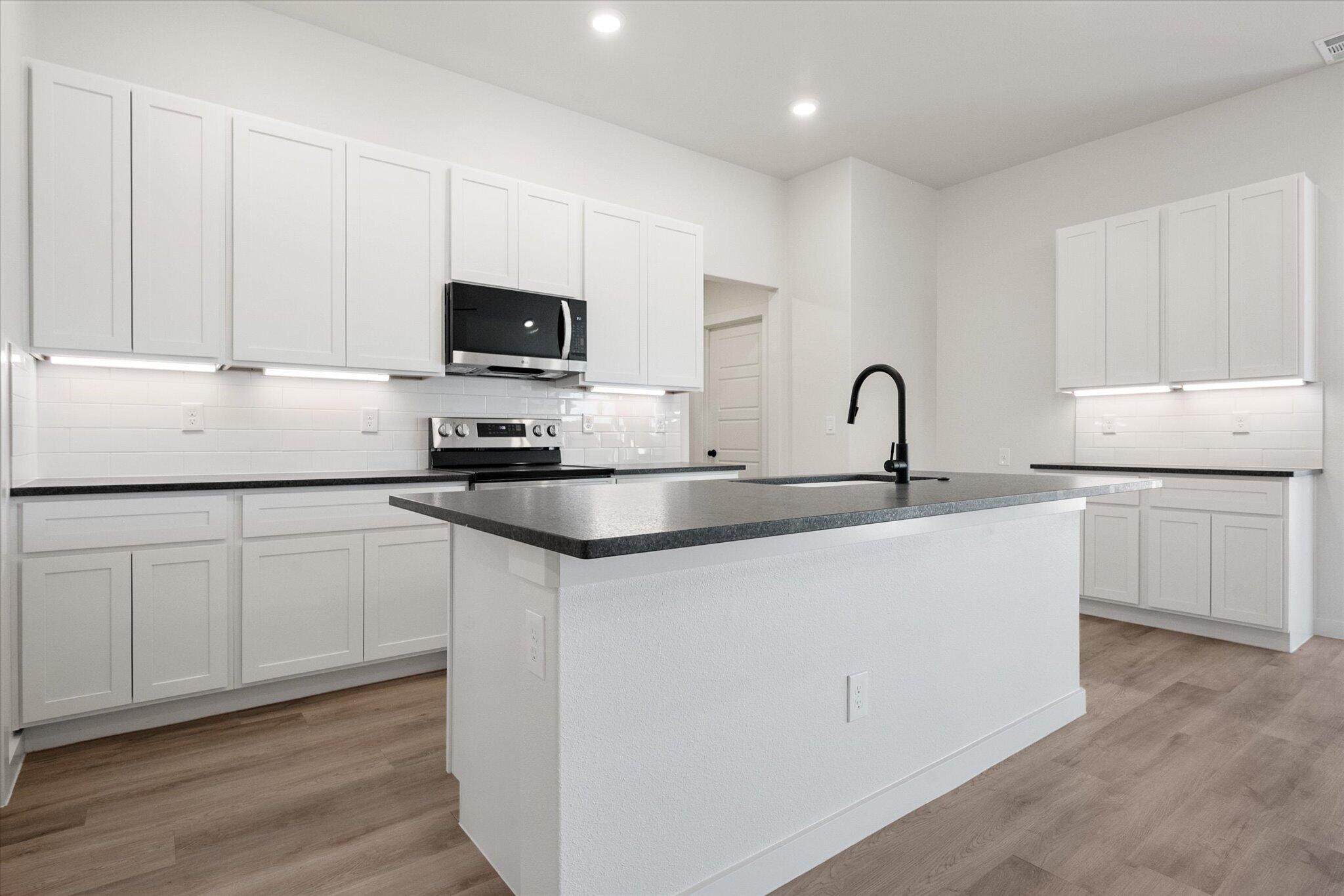 2403 Helena Avenue Lubbock, TX 79407 - Photo 13 of 25 a kitchen with appliances a sink and cabinets