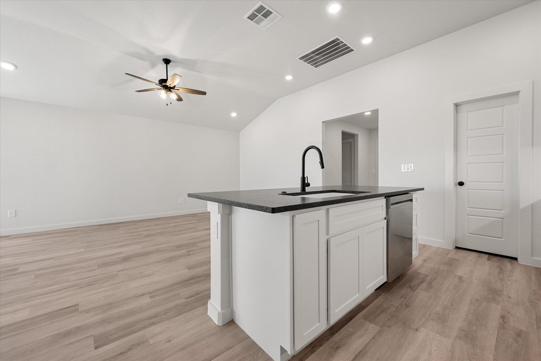 2403 Helena Avenue Lubbock, TX 79407 - Photo 15 of 25 a kitchen with a sink cabinets and wooden floor