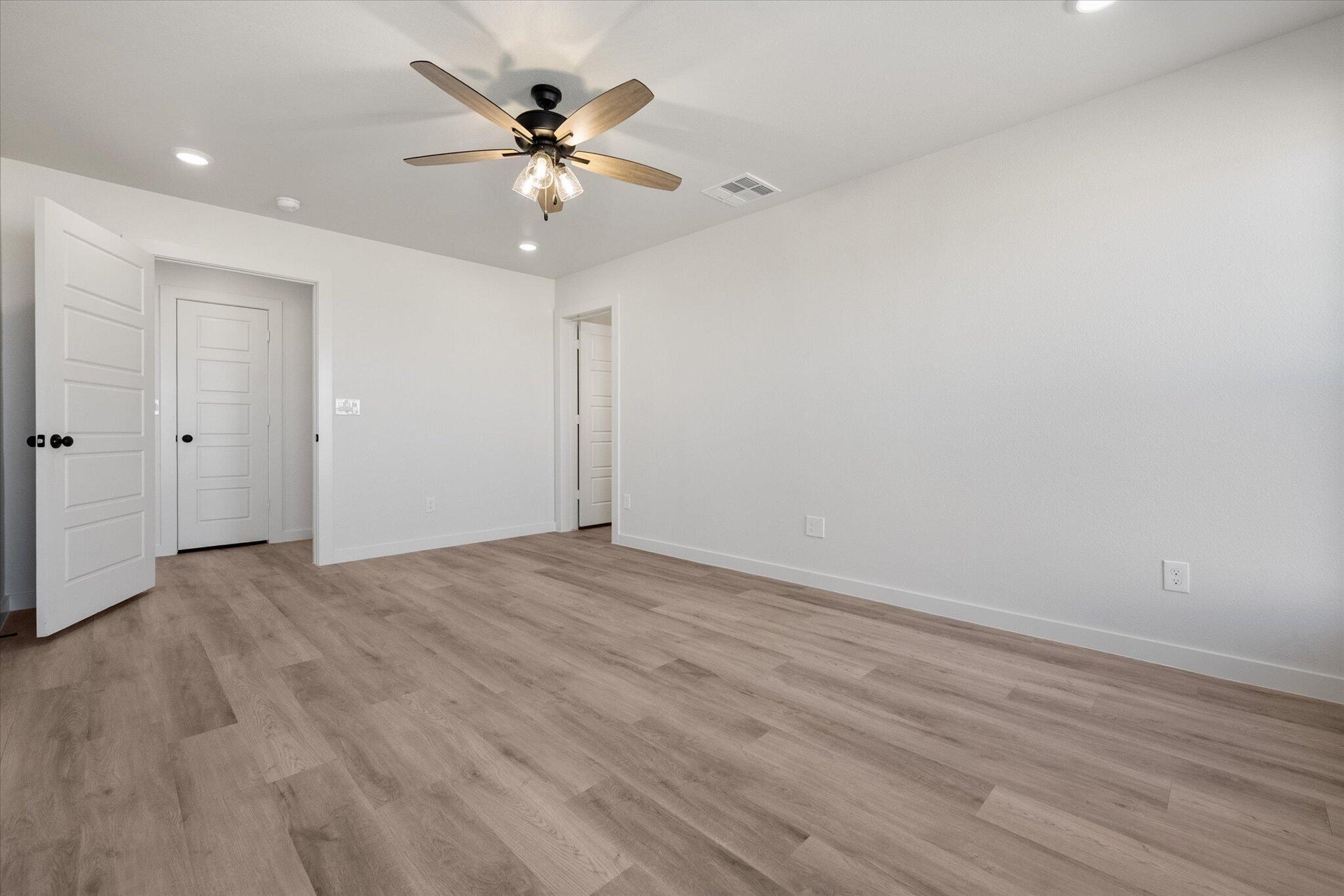 2403 Helena Avenue Lubbock, TX 79407 - Photo 18 of 25 wooden floor in an empty room with a fan