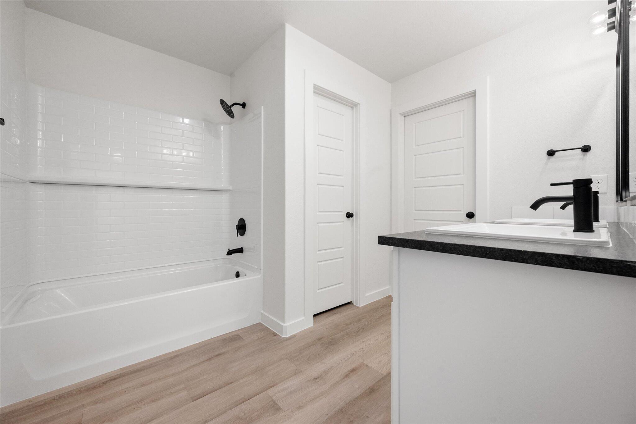 2403 Helena Avenue Lubbock, TX 79407 - Photo 19 of 25 a bathroom with a bathtub and a sink