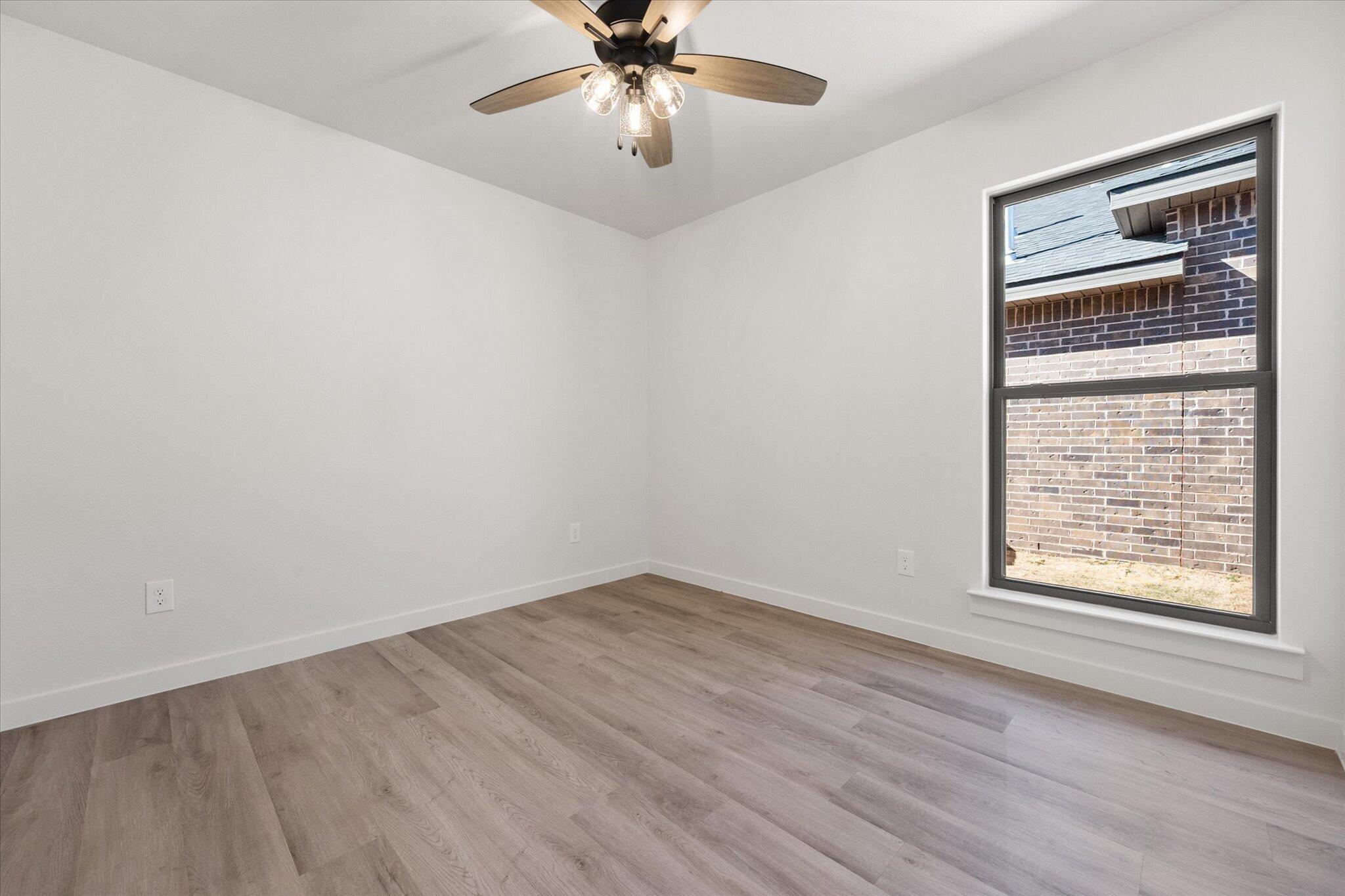 2403 Helena Avenue Lubbock, TX 79407 - Photo 21 of 25 an empty room with windows and fan