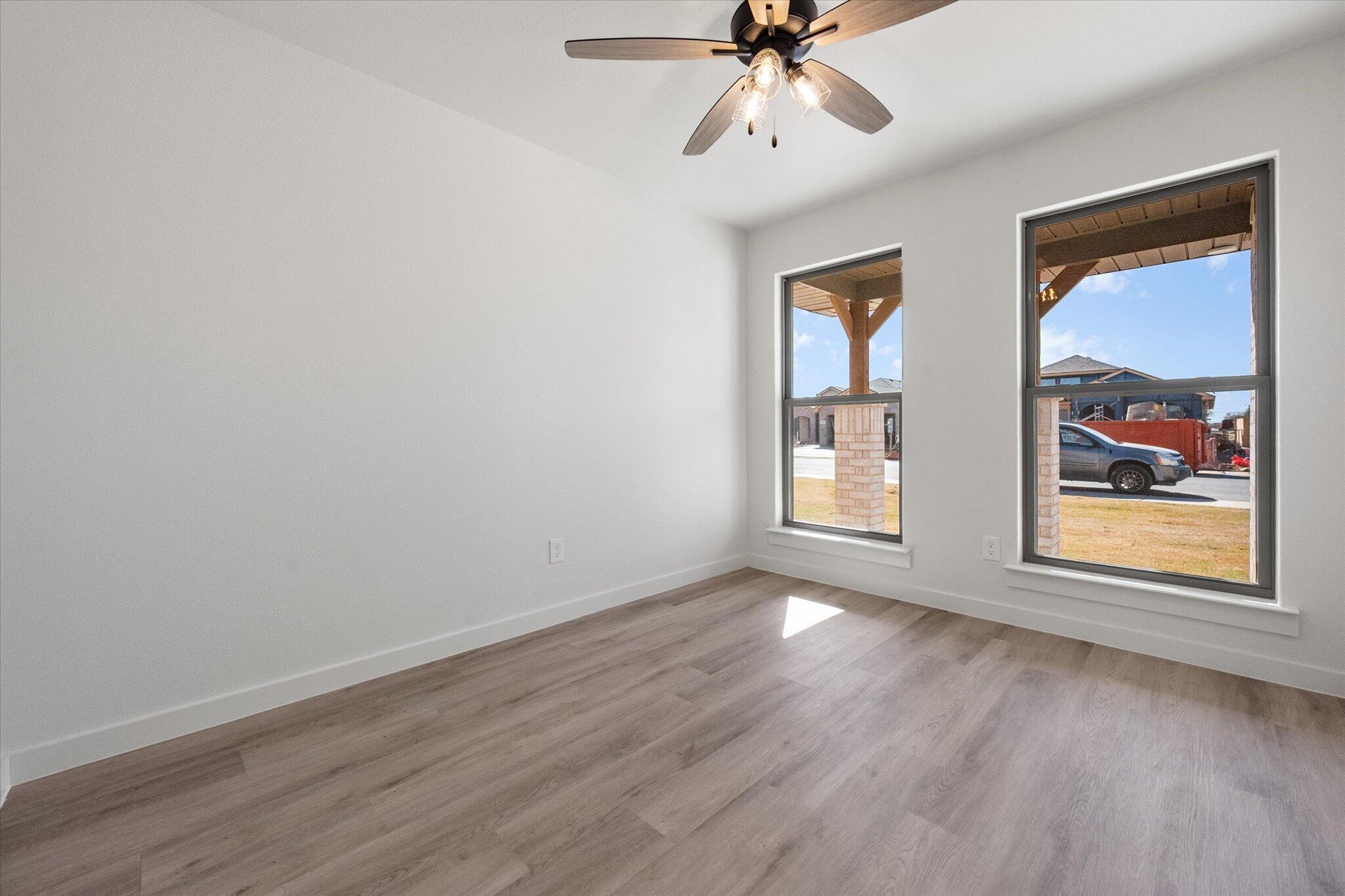 2403 Helena Avenue Lubbock, TX 79407 - Photo 22 of 25 a view of an empty room with wooden floor and a window