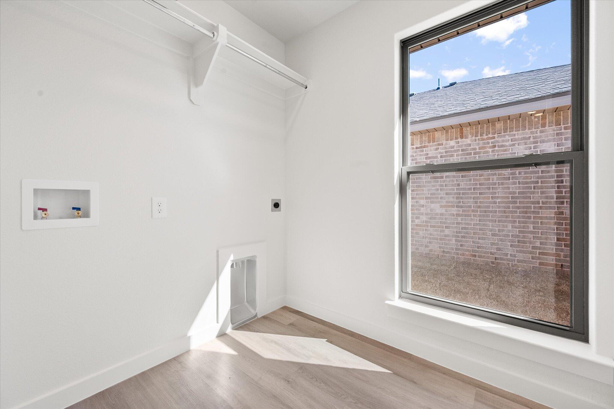 2403 Helena Avenue Lubbock, TX 79407 - Photo 24 of 25 a view of an empty room with wooden floor and a window
