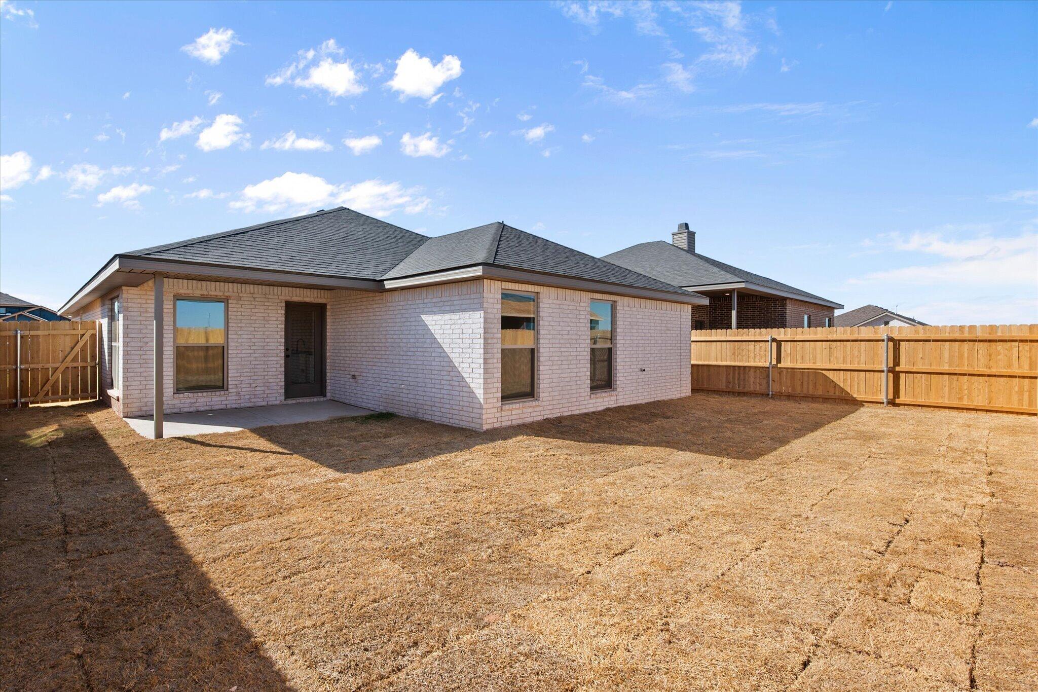 2403 Helena Avenue Lubbock, TX 79407 - Photo 25 of 25 a front view of a house with a yard and garage