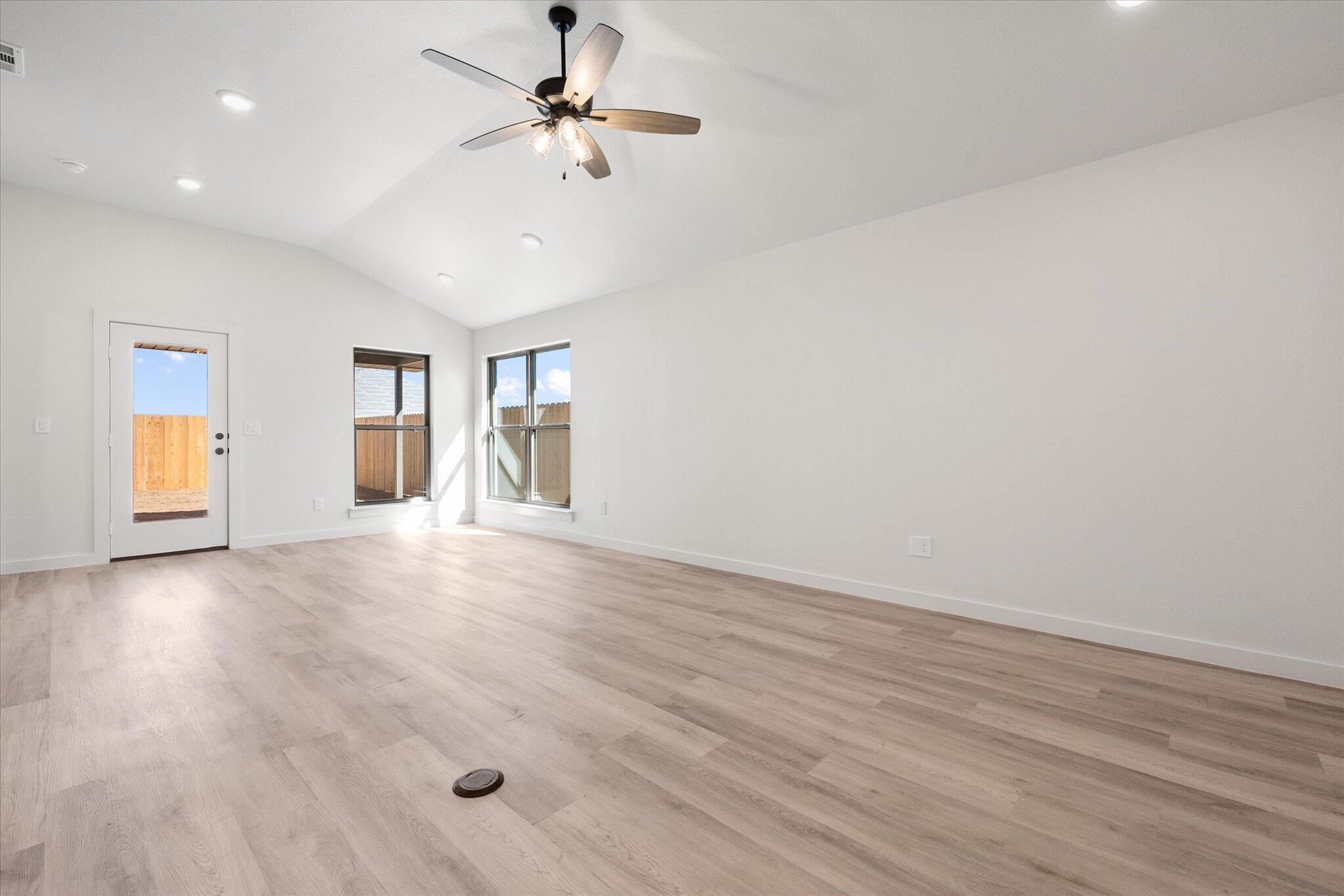2403 Helena Avenue Lubbock, TX 79407 - Photo 5 of 25 wooden floor in an empty room with a window