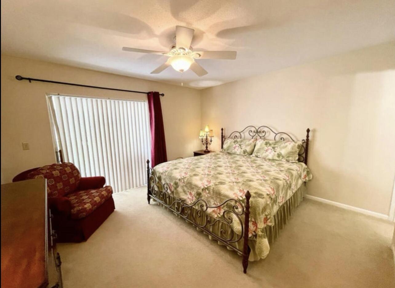 2600 Southeast Ocean Boulevard, Unit A2 Stuart, FL 34996 - Photo 12 of 16 a spacious bedroom with a bed and a chandelier