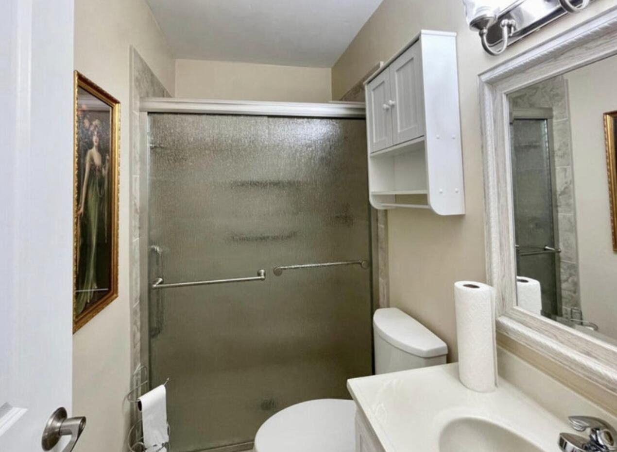2600 Southeast Ocean Boulevard, Unit A2 Stuart, FL 34996 - Photo 14 of 16 a white toilet sitting next to a bathroom sink