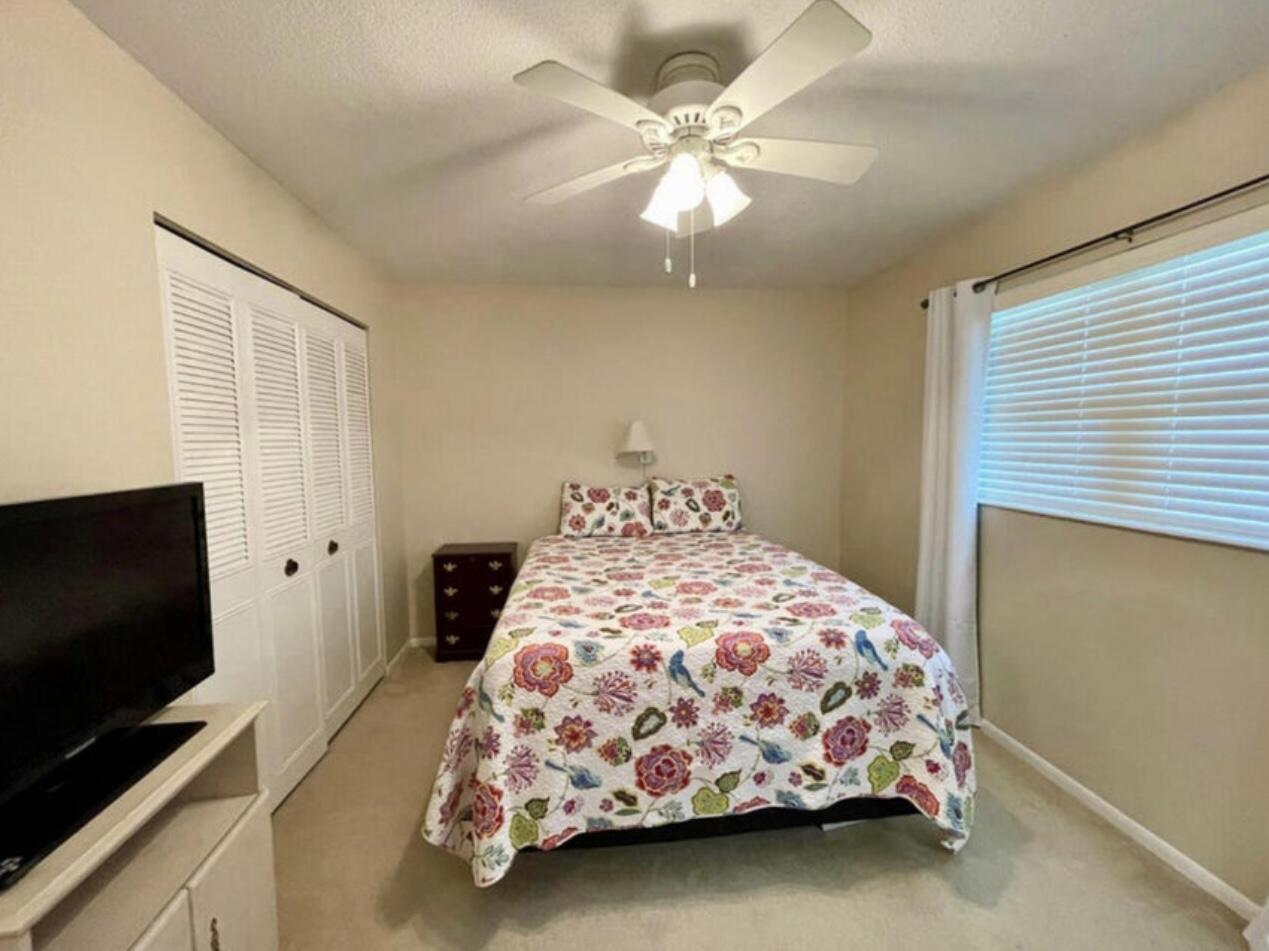 2600 Southeast Ocean Boulevard, Unit A2 Stuart, FL 34996 - Photo 15 of 16 a bedroom with a bed and a flat screen tv