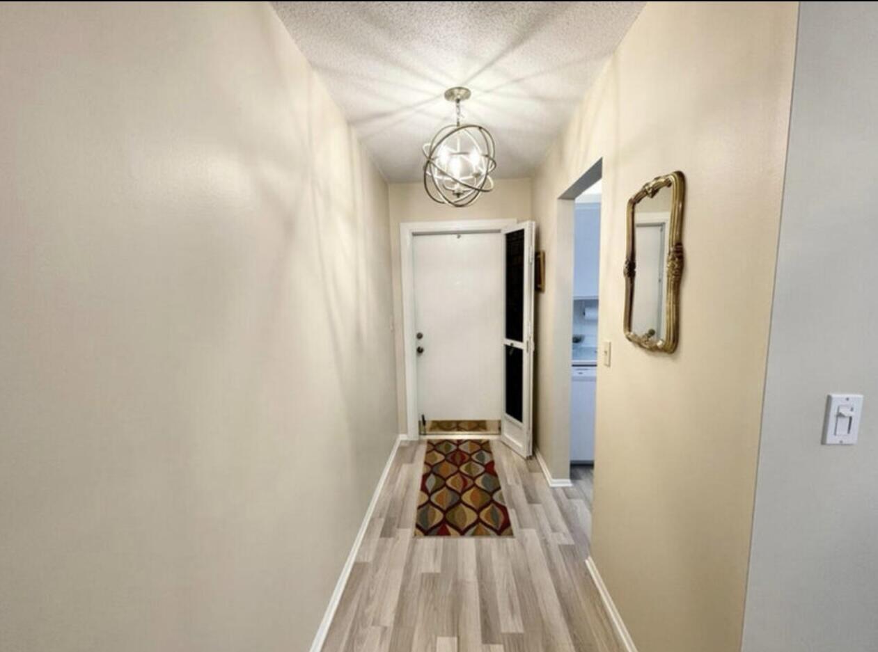 2600 Southeast Ocean Boulevard, Unit A2 Stuart, FL 34996 - Photo 5 of 16 a view of a hallway with wooden floor