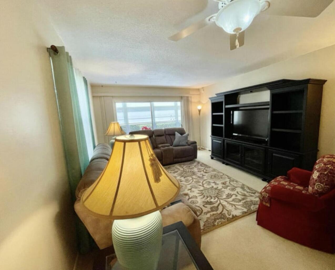 2600 Southeast Ocean Boulevard, Unit A2 Stuart, FL 34996 - Photo 7 of 16 a living room with furniture and a flat screen tv