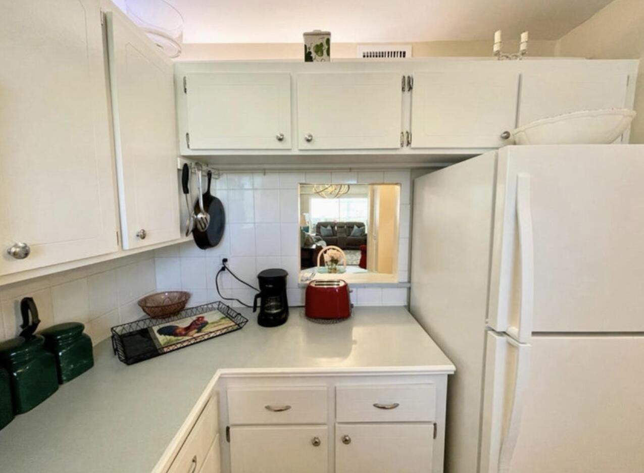 2600 Southeast Ocean Boulevard, Unit A2 Stuart, FL 34996 - Photo 10 of 16 a kitchen with a refrigerator and white cabinets