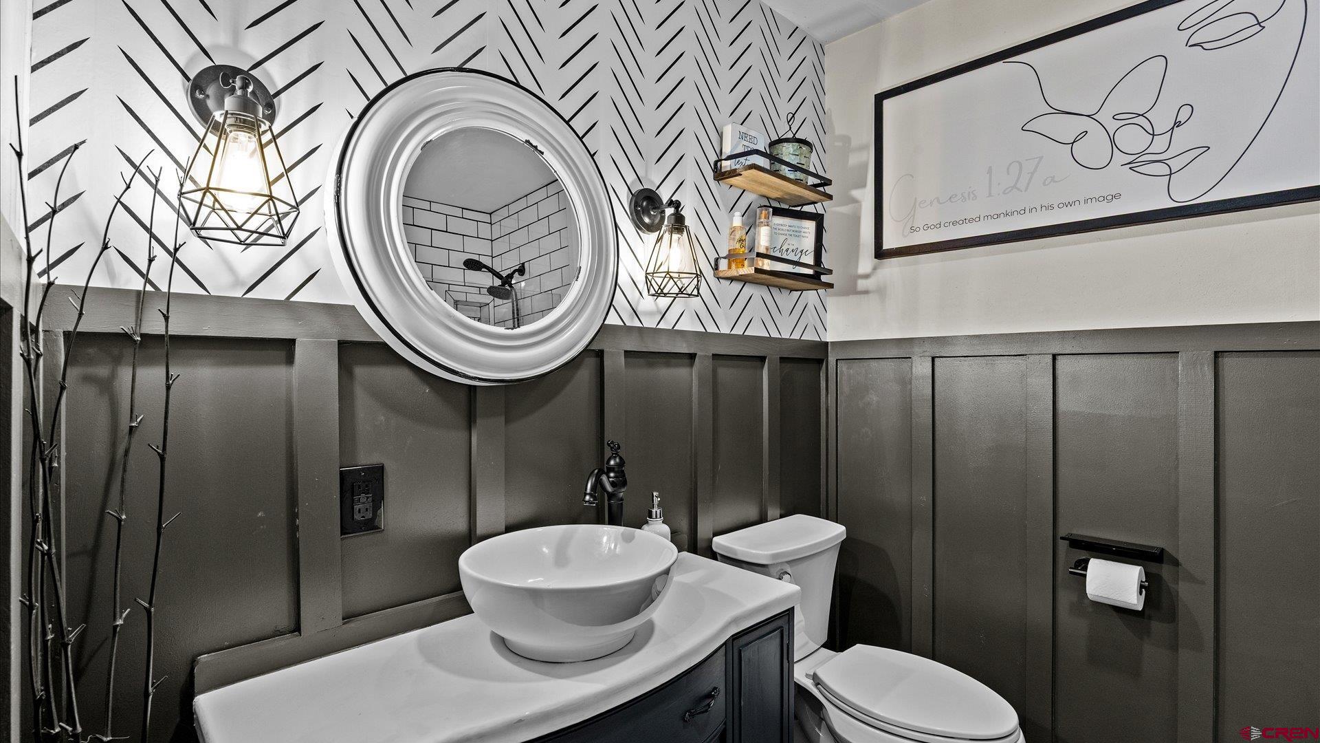1761 G Road Delta, CO 81416 - Photo 16 of 43 a bathroom with a toilet a sink and mirror