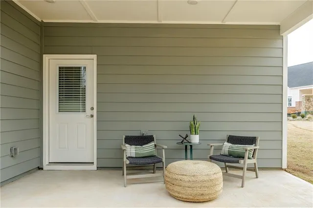 a backyard of a house with table and chairs