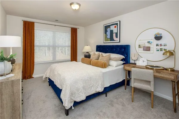 a spacious bedroom with a bed a window and dresser