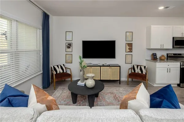 a living room with furniture and a flat screen tv