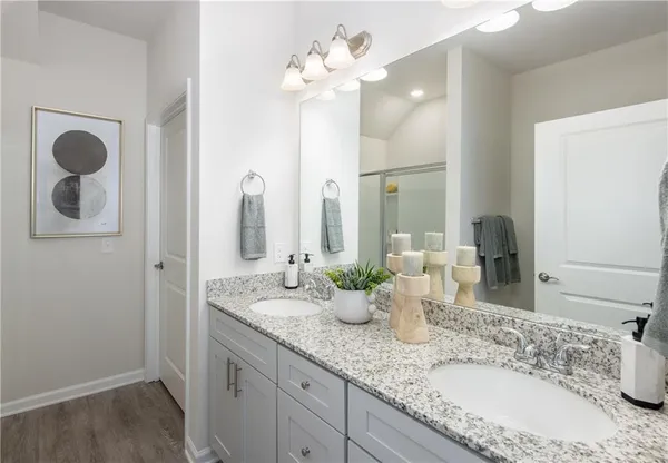a bathroom with double vanity sinks a vanity and a mirror