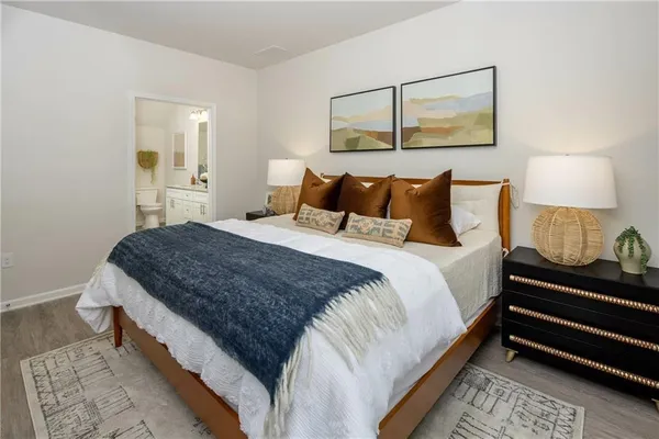 a bedroom with bed and night stand