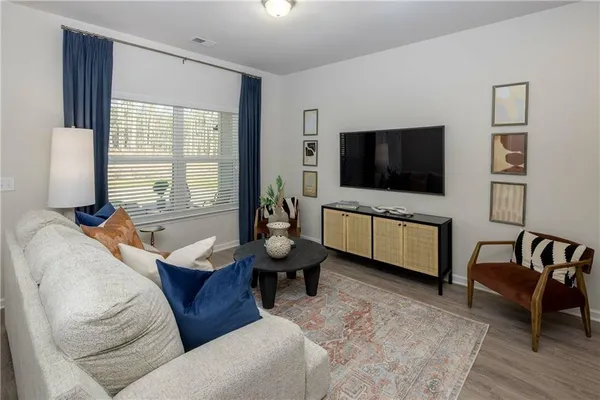 a living room with furniture and a flat screen tv