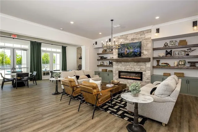 a living room with furniture fireplace and a large window