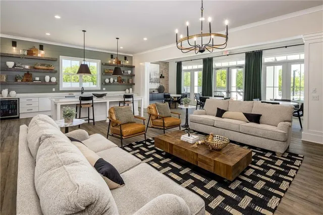 a living room with furniture dining table and a chandelier
