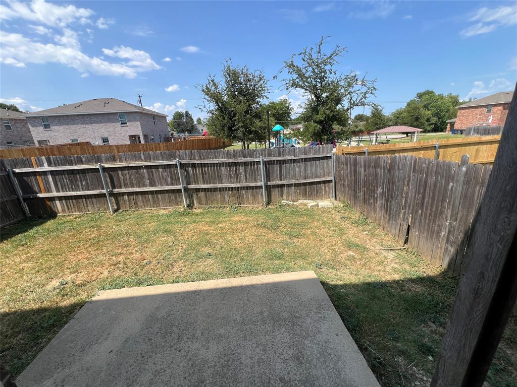 906 Parkplace Ridge Princeton, TX 75407 - Photo 23 of 25 Private fenced backyard with a concrete patio
