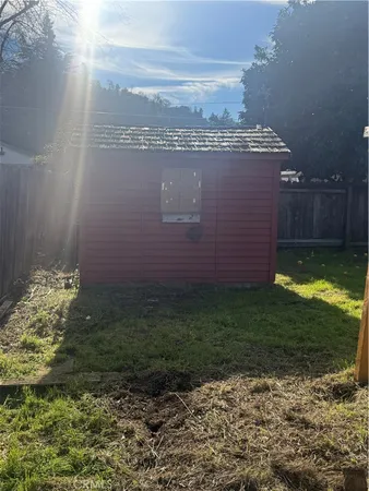a view of a backyard with plants and a lake view