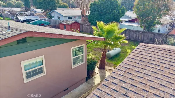 a view of a house with backyard and sitting area