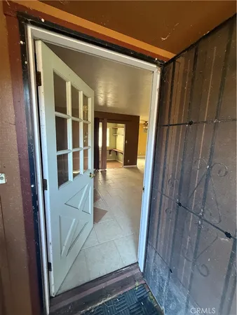 a view of a hallway with wooden floor and entryway