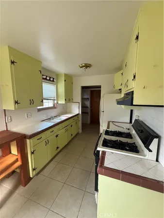 a kitchen with a stove a sink and a refrigerator