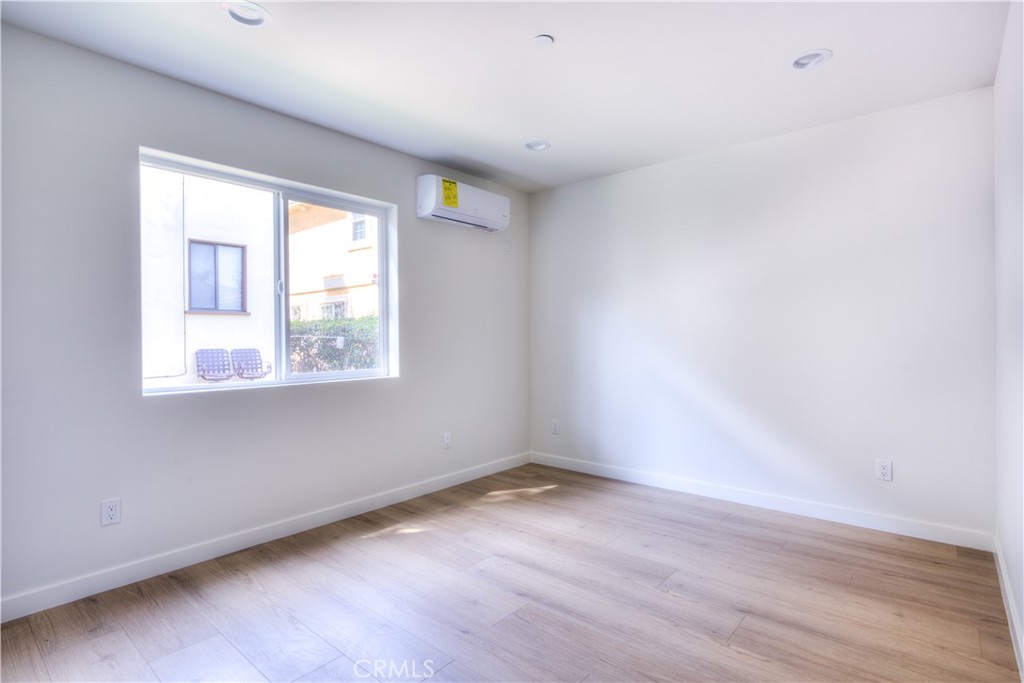 1806 South 8th Street, Unit A Alhambra, CA 91803 - Photo 15 of 23 an empty room with wooden floor and windows