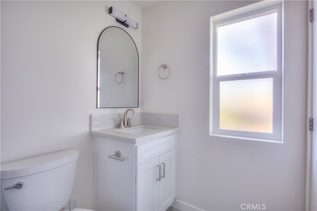 1806 South 8th Street, Unit A Alhambra, CA 91803 - Photo 19 of 23 a bathroom with a sink a toilet and a mirror