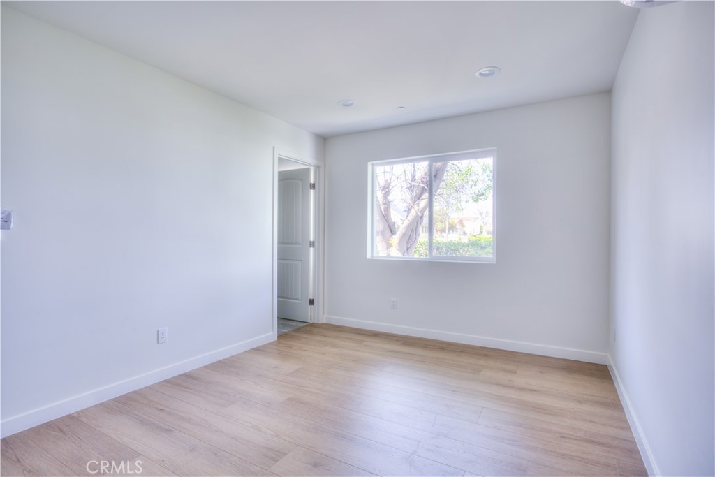 1806 South 8th Street, Unit A Alhambra, CA 91803 - Photo 21 of 23 an empty room with wooden floor and windows
