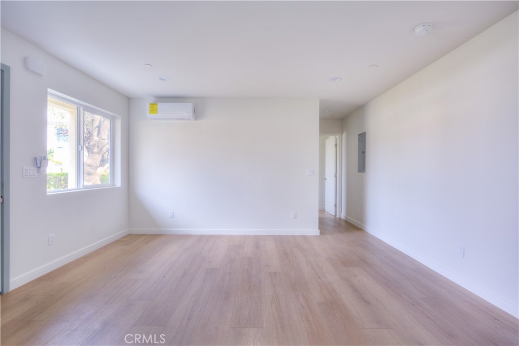 1806 South 8th Street, Unit A Alhambra, CA 91803 - Photo 6 of 23 a view of an empty room with wooden floor and a window