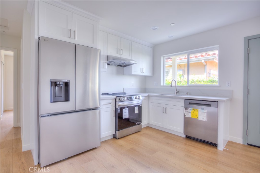 1806 South 8th Street, Unit A Alhambra, CA 91803 - Photo 8 of 23 a kitchen with stainless steel appliances a refrigerator sink and stove