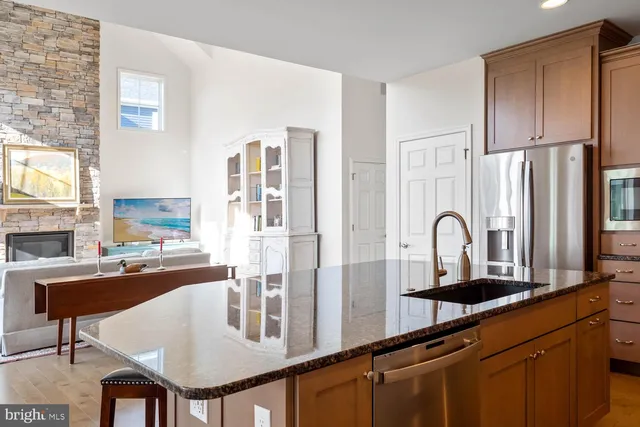 a bathroom with a granite countertop double vanity sink and mirror