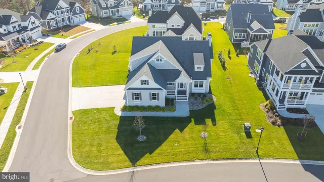 a view of a hallway with wooden floor and entryway