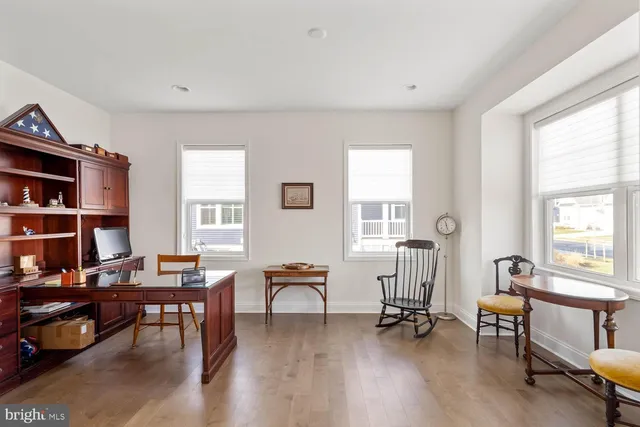 a bathroom with a granite countertop sink toilet a mirror a vanity and shower