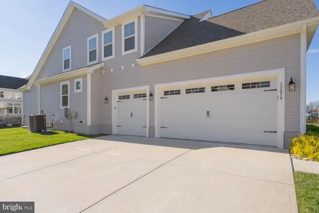 a living room with furniture a large window and wooden floor