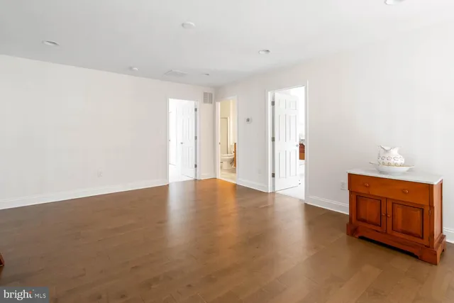 a bathroom with a toilet sink vanity and shower