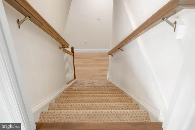 an aerial view of a swimming pool with outdoor seating