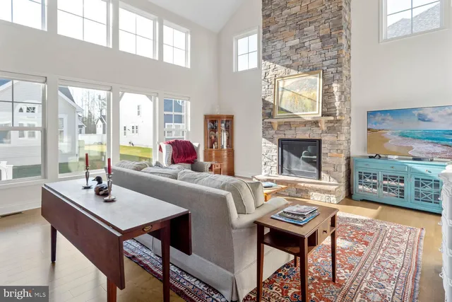 a living room with furniture wooden floor and a rug