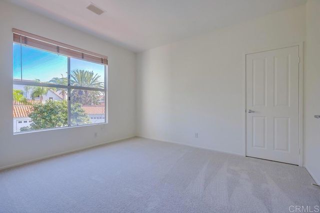 a bathroom with a granite countertop sink a mirror and shower