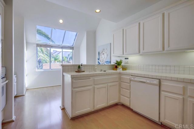 a kitchen with sink cabinets and window