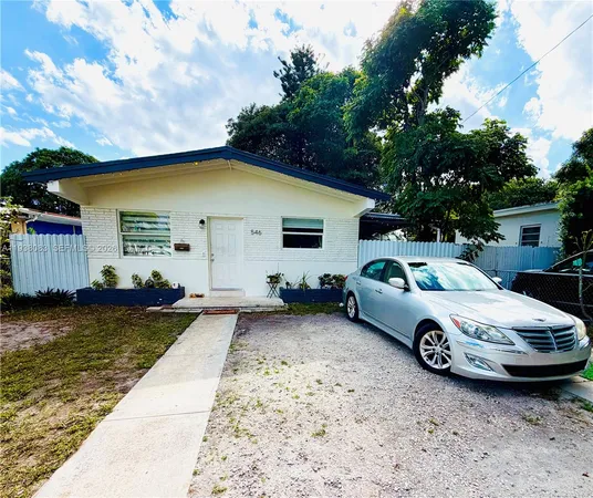 a front view of a house with parking space