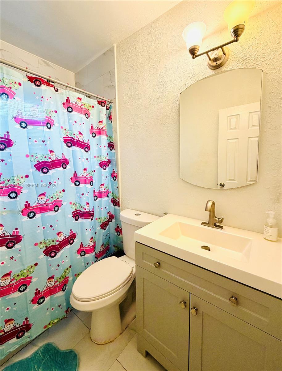 546 East 39th Street Hialeah, FL 33013 - Photo 13 of 24 a bathroom with a sink and a mirror